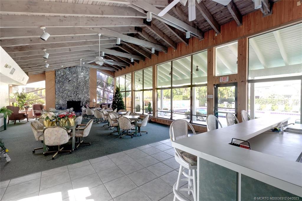 800 Northwest Fork Road, Unit 86 Stuart, FL 34994 - Photo 29 of 40 a living room with furniture and a large window