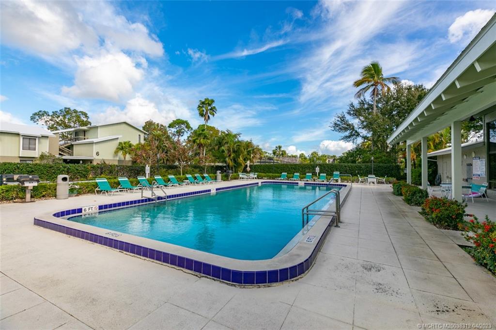 800 Northwest Fork Road, Unit 86 Stuart, FL 34994 - Photo 31 of 40 a view of swimming pool from a lounge chair