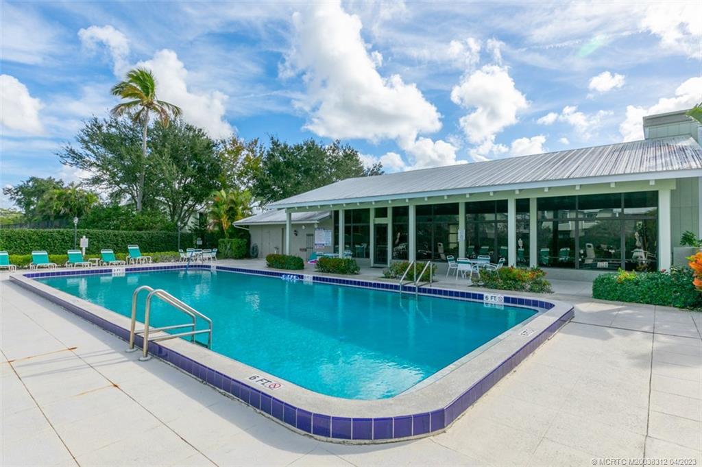 800 Northwest Fork Road, Unit 86 Stuart, FL 34994 - Photo 32 of 40 a view of a house with swimming pool and a porch