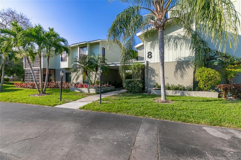 800 Northwest Fork Road, Unit 86 Stuart, FL 34994 - Photo 36 of 40 a view of a house with a yard and palm trees