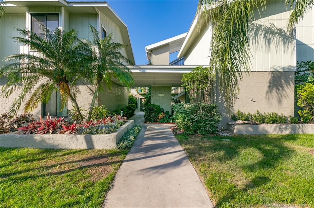 800 Northwest Fork Road, Unit 86 Stuart, FL 34994 - Photo 37 of 40 a view of a house with a yard and potted plants
