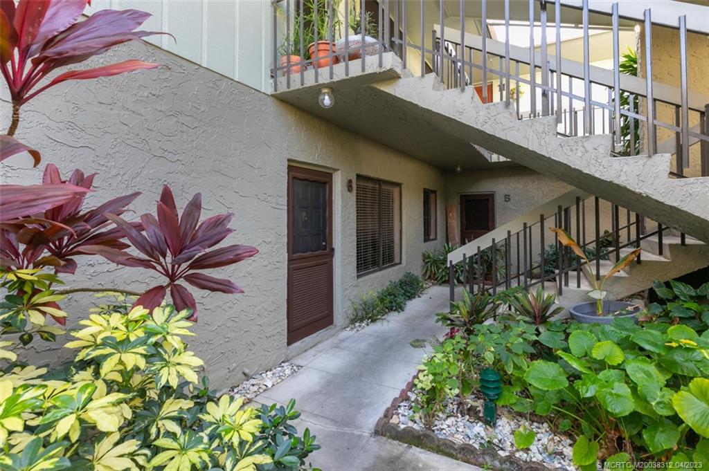 800 Northwest Fork Road, Unit 86 Stuart, FL 34994 - Photo 4 of 40 a view of a house with a flower garden