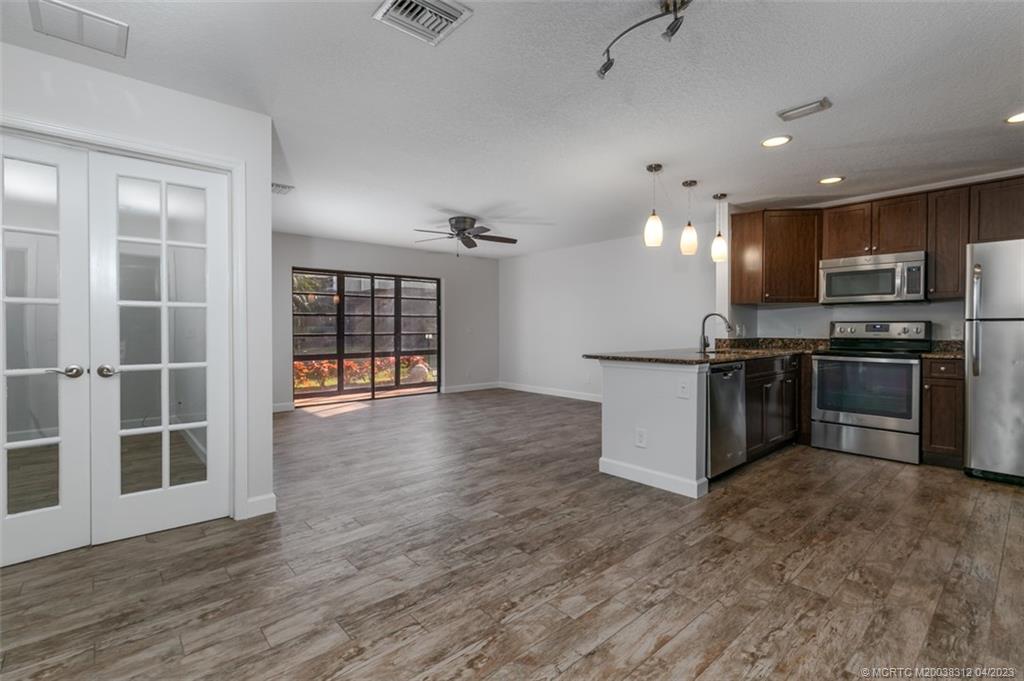 800 Northwest Fork Road, Unit 86 Stuart, FL 34994 - Photo 5 of 40 a view of kitchen with stainless steel appliances granite countertop a stove top oven a sink and a granite counter top