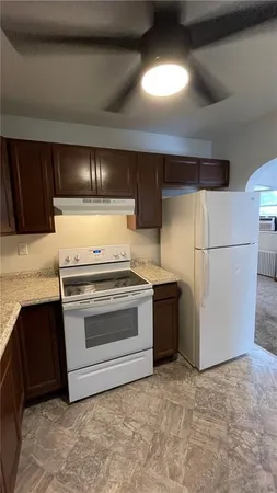 a kitchen with a stove and a refrigerator