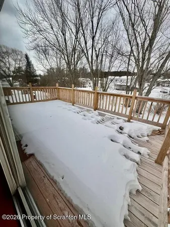 a view of roof deck with large trees