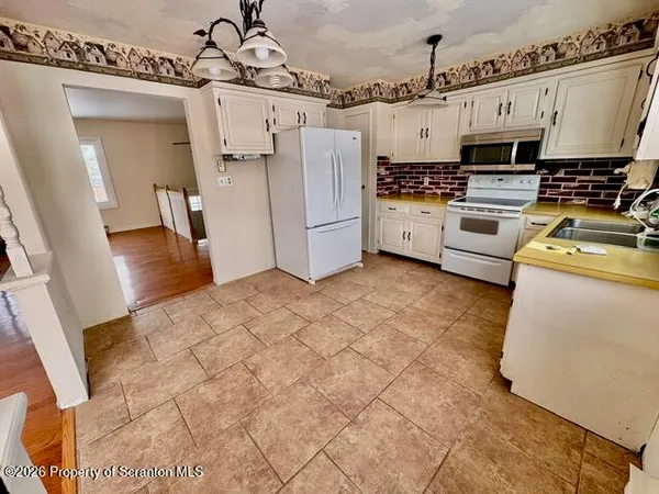 a kitchen with stainless steel appliances a stove top oven a sink and a refrigerator