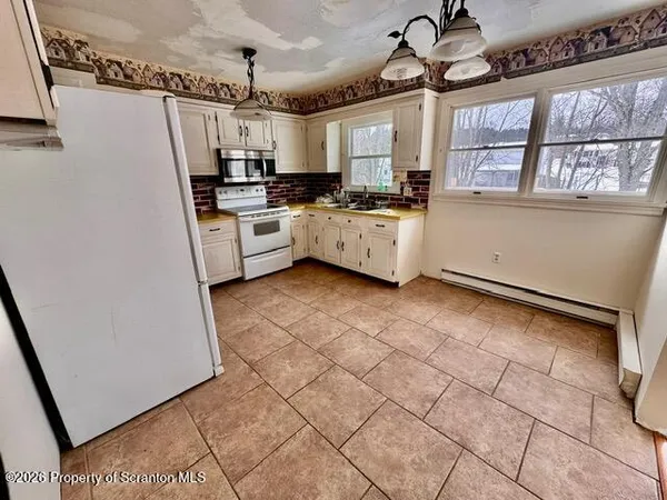 a kitchen with stainless steel appliances a refrigerator a sink a stove a microwave and cabinets