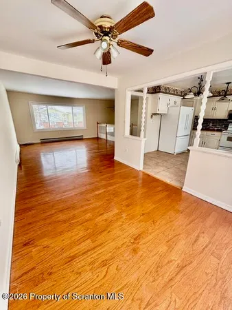 a view of a kitchen with furniture and a ceiling fan
