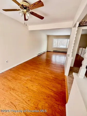 a view of a room with wooden floor and staircase