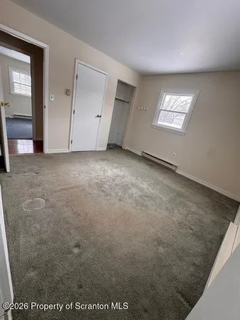 a view of an empty room with a window