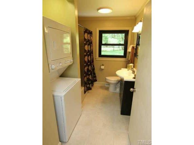 611 Crosby Road Durham, NC 27704 - Photo 21 of 25 Remodeled Hall Bath has new ceramic tile floors, fresh paint (no more floral wallpaper), stylish vanity, brushed nickel hardware and light fixture. Inside the BA to the right is a full linen closet with shelving for lots of bath and laundry storage.