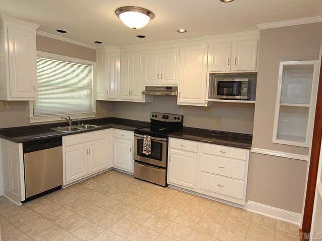 611 Crosby Road Durham, NC 27704 - Photo 8 of 25 EVERYTHING NEW - Stainless Appliances include Dishwasher, Smooth-Top Range, Hood, & Microwave. Note deep stainless sink w/faucet, crown molding, chair rail, microwave shelf, display shelving, & 2 bottom deep drawers.