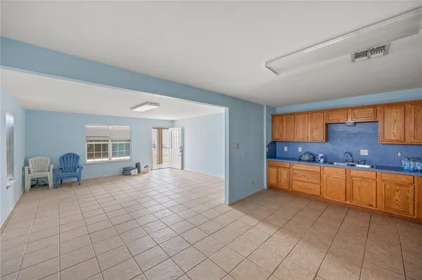 a large white kitchen with cabinets