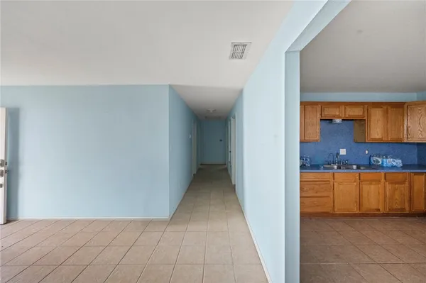 a view of a kitchen from the hallway