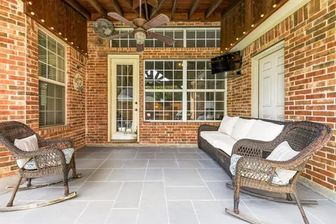 a balcony with furniture and a window