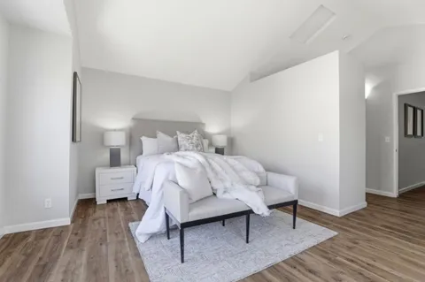 a bedroom with a bed and wooden floor