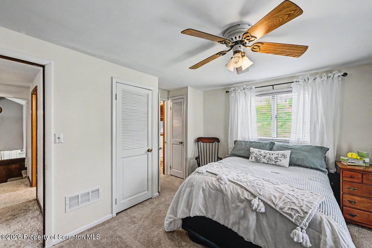 719 Scott Road Clarks Summit, PA 18411 - Photo 26 of 51 a bedroom with a bed and a ceiling fan
