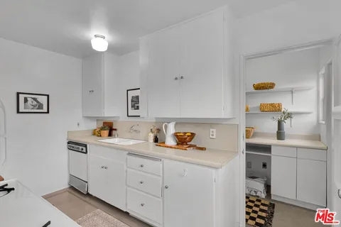 a kitchen with a sink cabinets and window