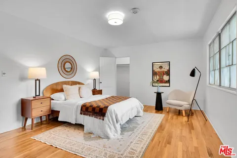 a bedroom with a bed and a lamp