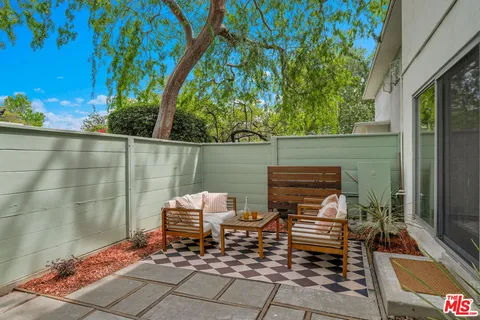 a view of a chairs and table in the patio