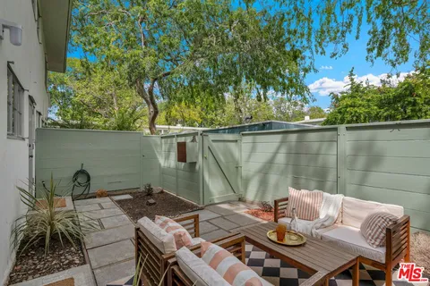 a view of a patio with a table and chairs