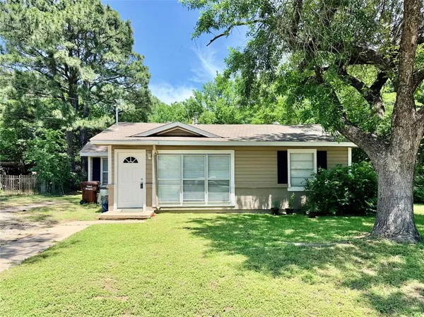 a front view of a house with a yard and porch