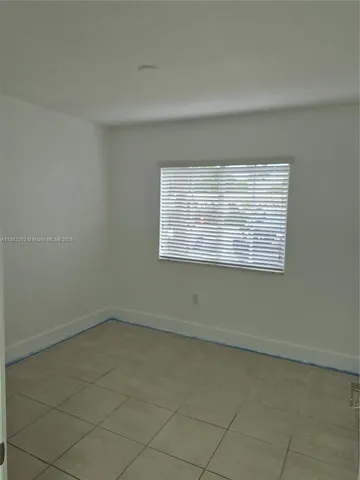an empty room with a empty space and window