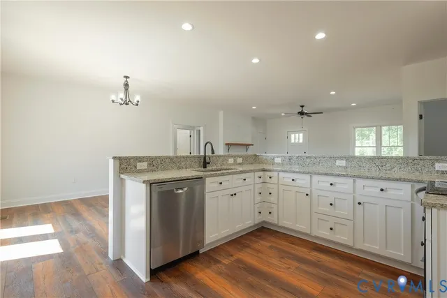 a spacious bathroom with a granite countertop double vanity and a mirror