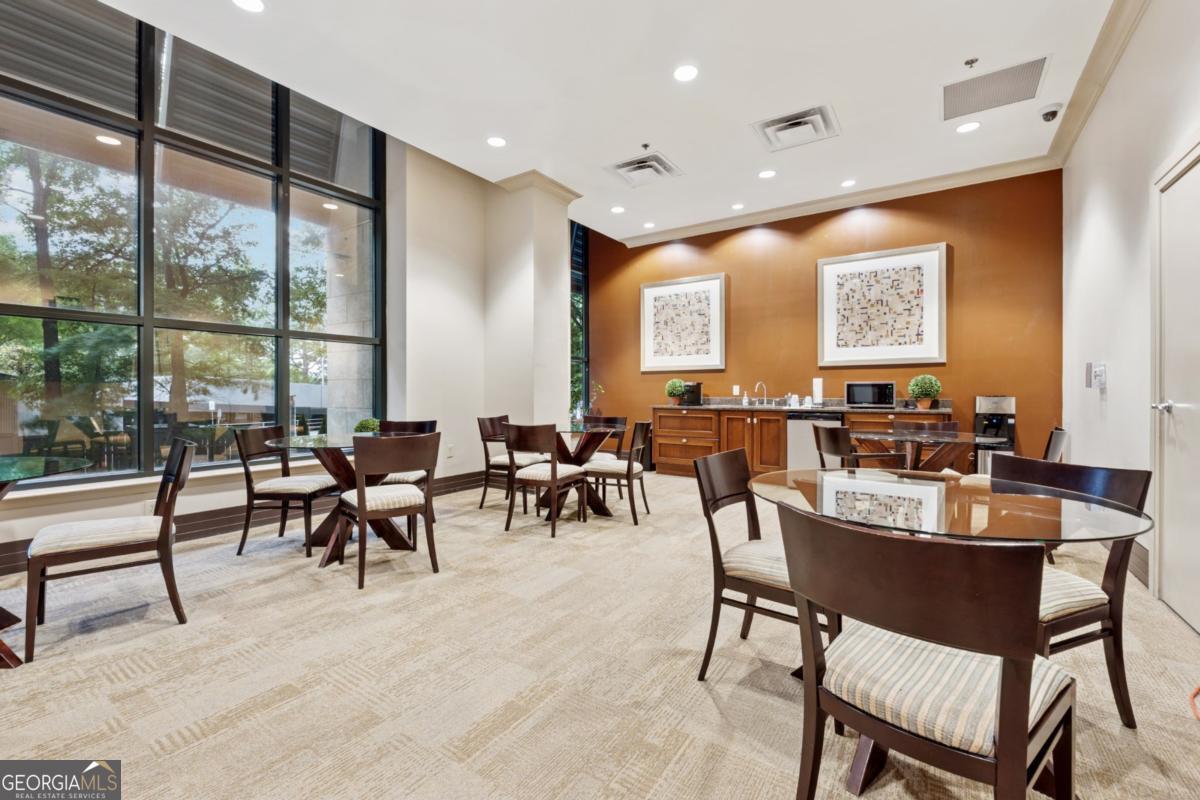 3040 Peachtree Road Northwest, Unit 702 Atlanta, GA 30305 - Photo 12 of 26 a view of a a dining room with furniture window and outside view