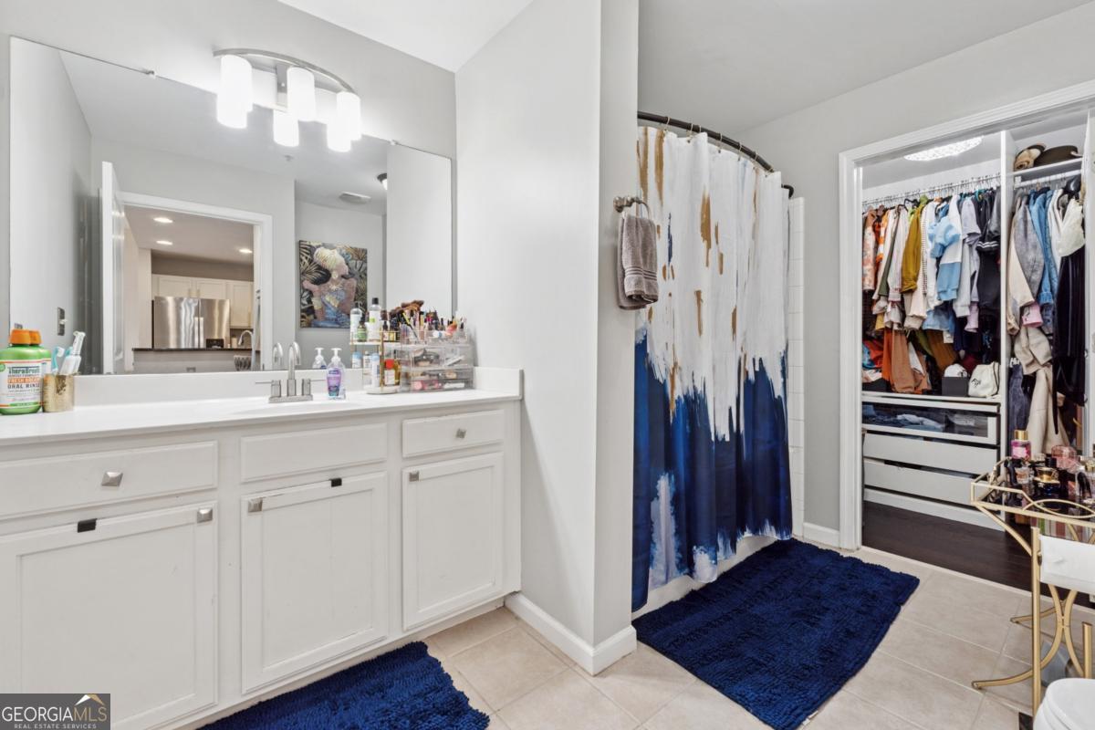 3040 Peachtree Road Northwest, Unit 702 Atlanta, GA 30305 - Photo 24 of 26 a bathroom with a sink and a mirror