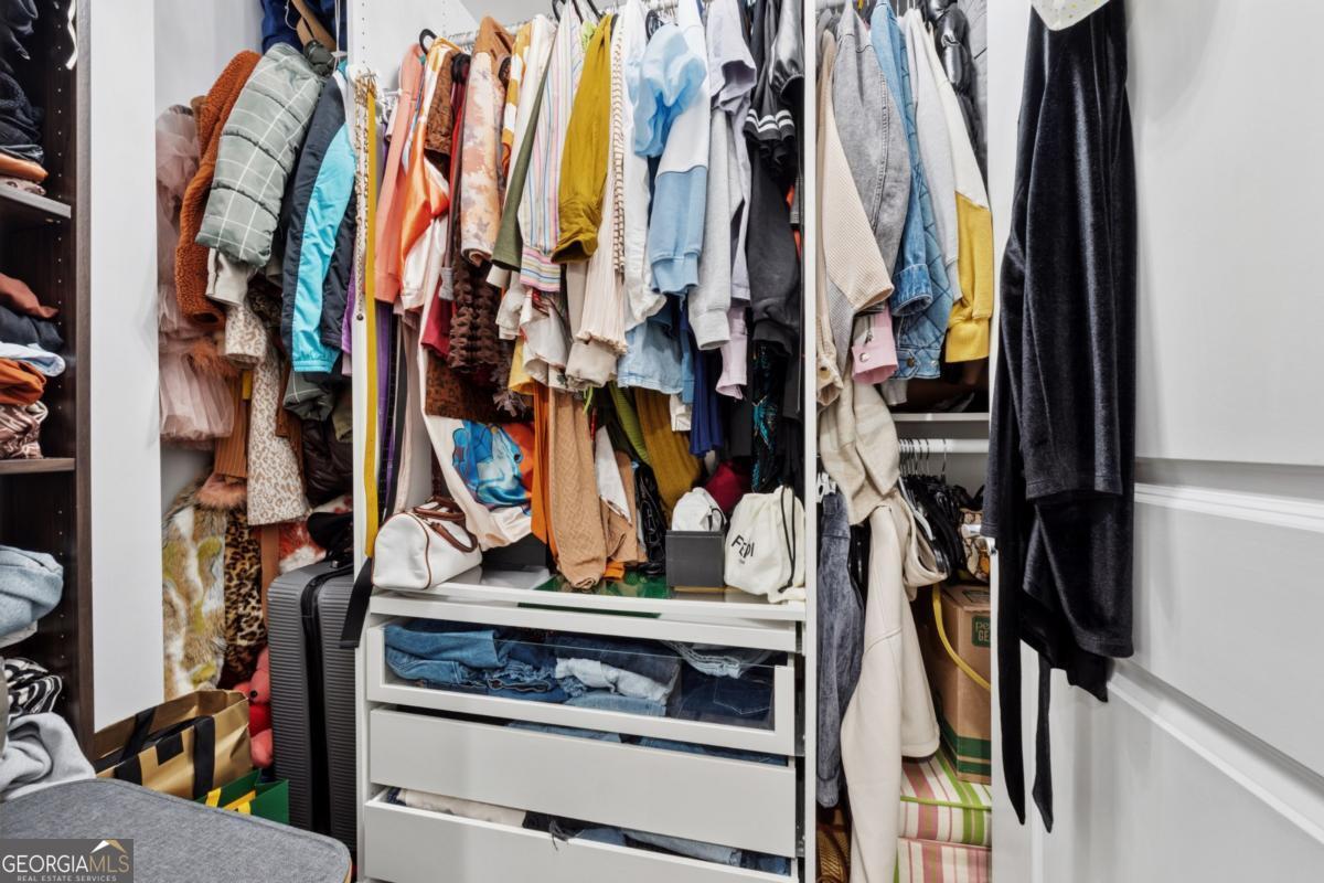 3040 Peachtree Road Northwest, Unit 702 Atlanta, GA 30305 - Photo 25 of 26 a view of walk in closet with clothes