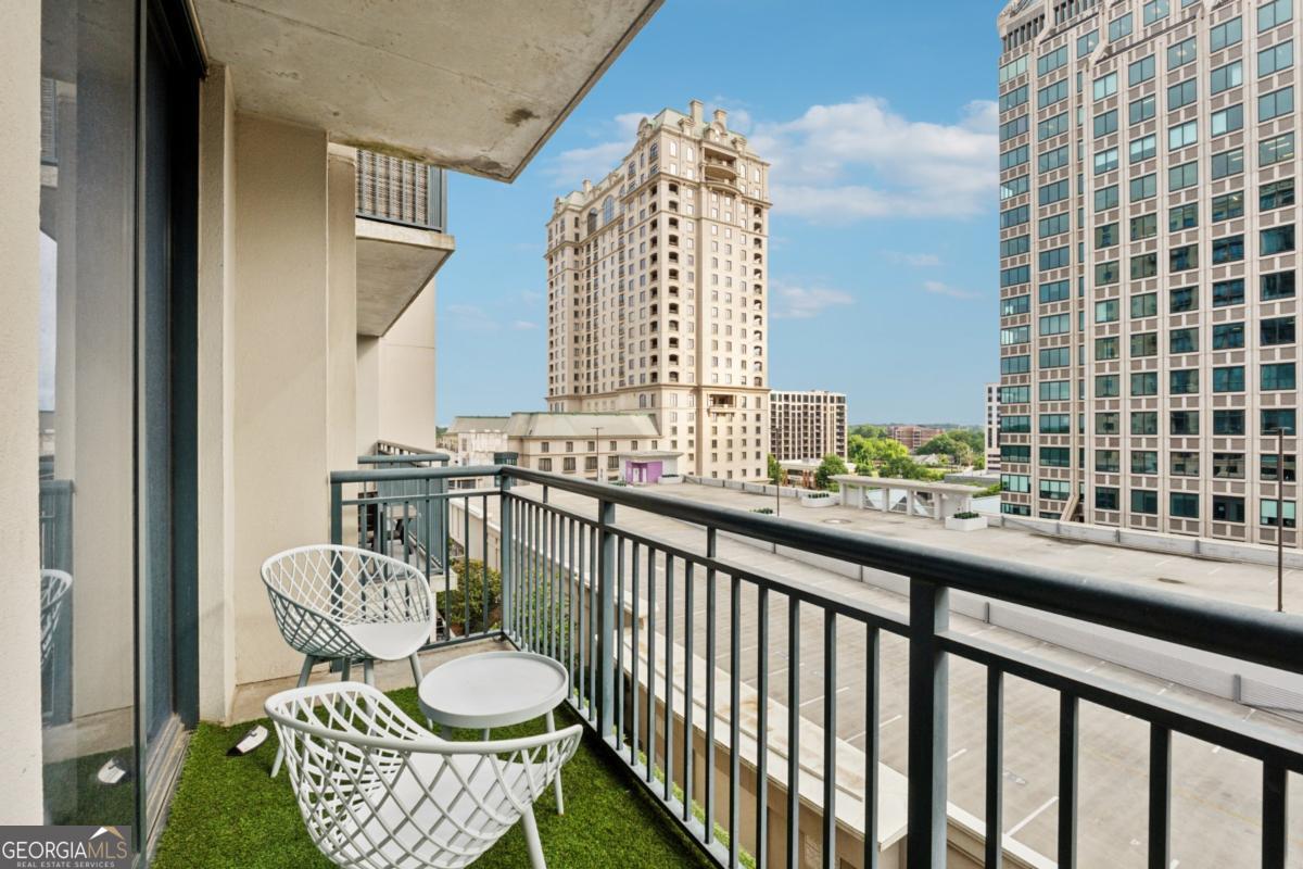 3040 Peachtree Road Northwest, Unit 702 Atlanta, GA 30305 - Photo 26 of 26 a view of a chair and table in the balcony