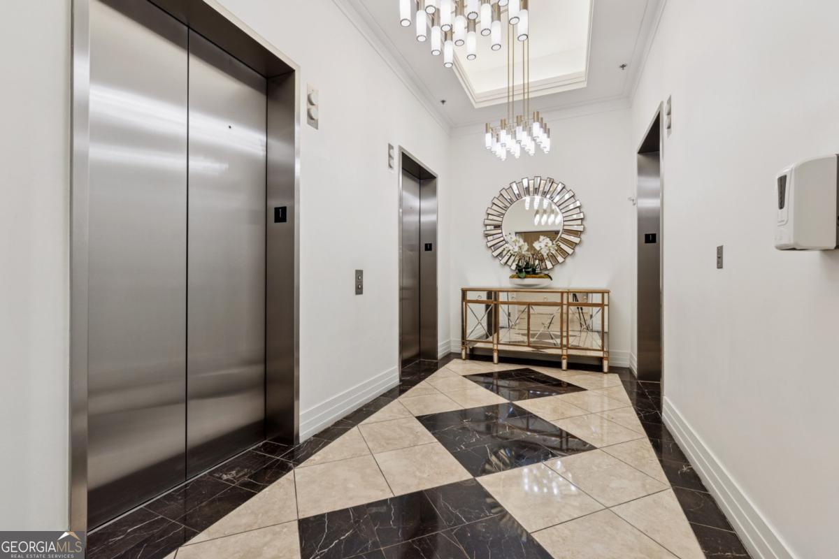 3040 Peachtree Road Northwest, Unit 702 Atlanta, GA 30305 - Photo 6 of 26 a bathroom with a chandelier and a shower
