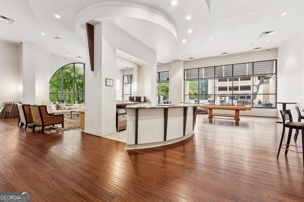 3040 Peachtree Road Northwest, Unit 702 Atlanta, GA 30305 - Photo 8 of 26 a living room with furniture and a large window