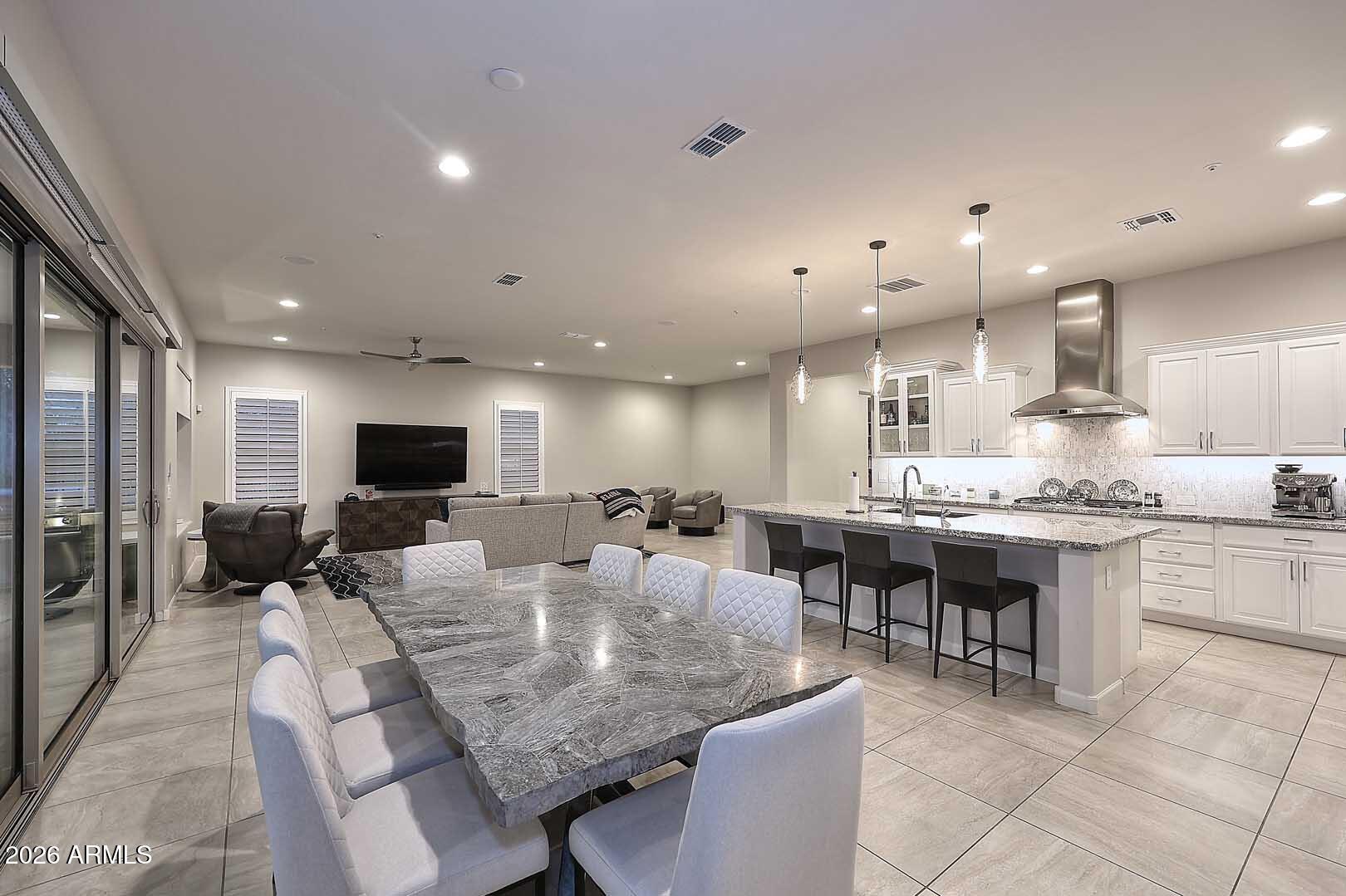 17916 East Cindercone Road Rio Verde, AZ 85263 - Photo 12 of 80 a large kitchen with a table and chairs