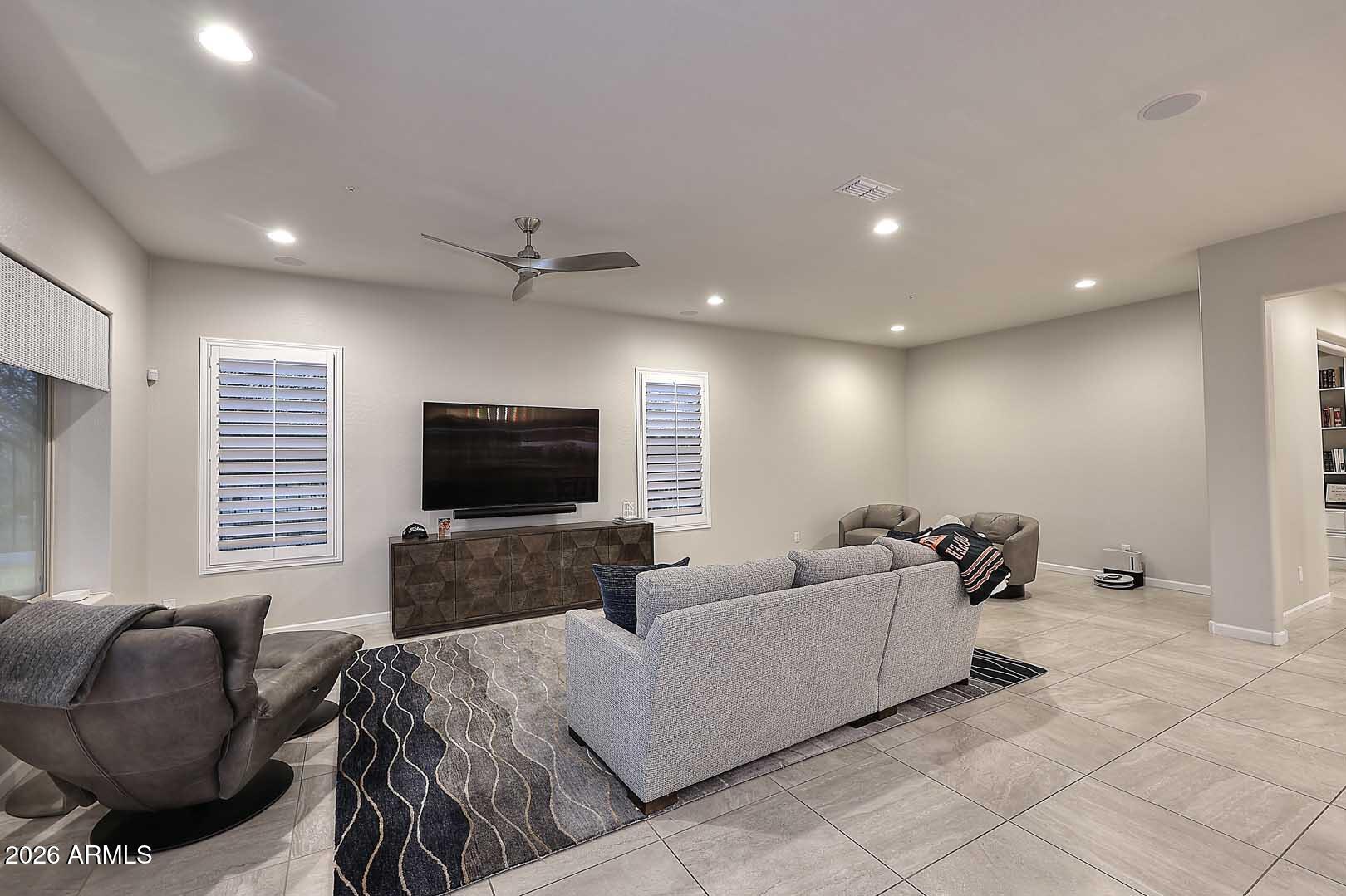 17916 East Cindercone Road Rio Verde, AZ 85263 - Photo 13 of 80 a living room with furniture and a flat screen tv