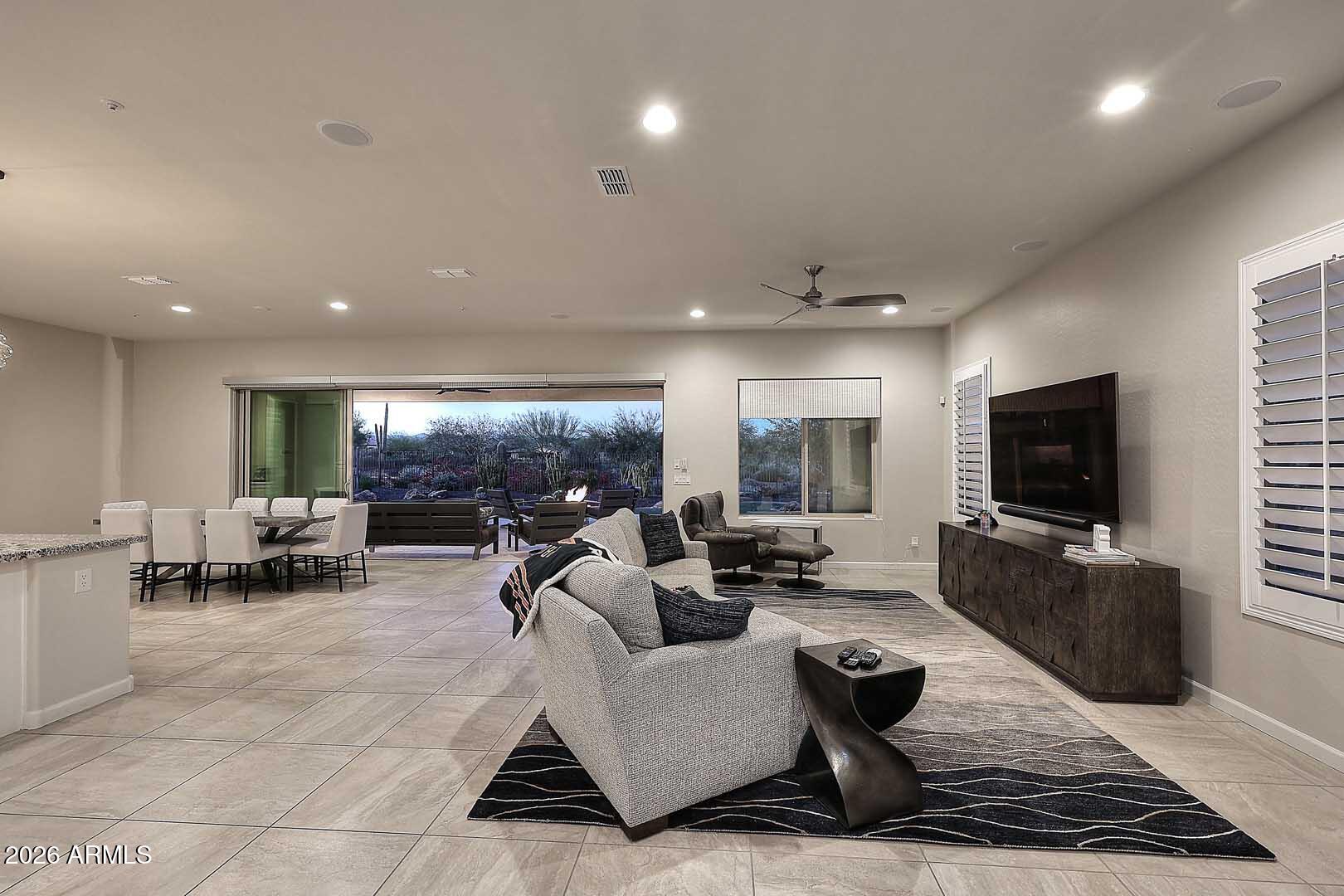 17916 East Cindercone Road Rio Verde, AZ 85263 - Photo 14 of 80 a living room with furniture and a flat screen tv