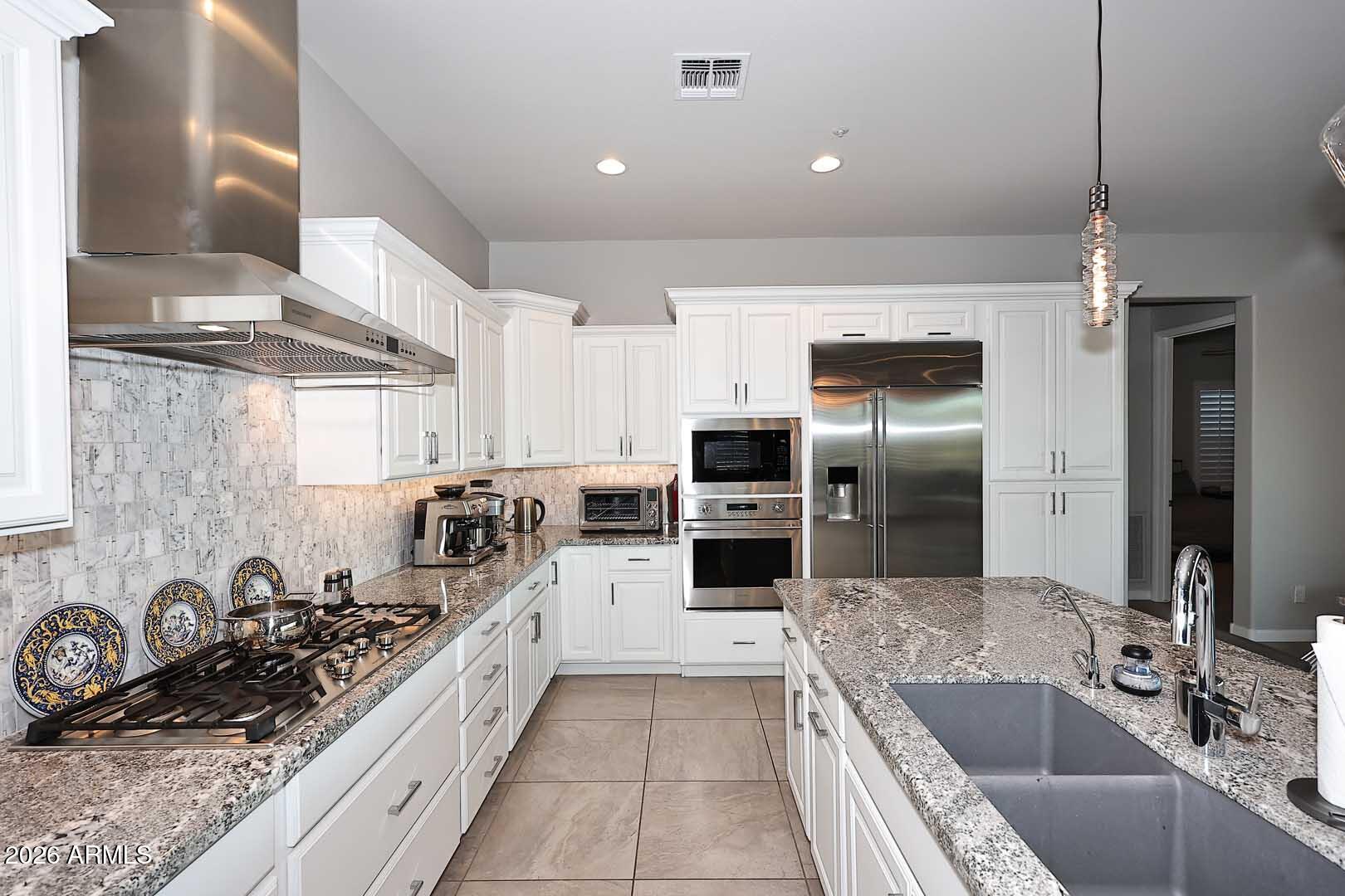 17916 East Cindercone Road Rio Verde, AZ 85263 - Photo 36 of 80 a kitchen with stainless steel appliances a sink a stove and a refrigerator