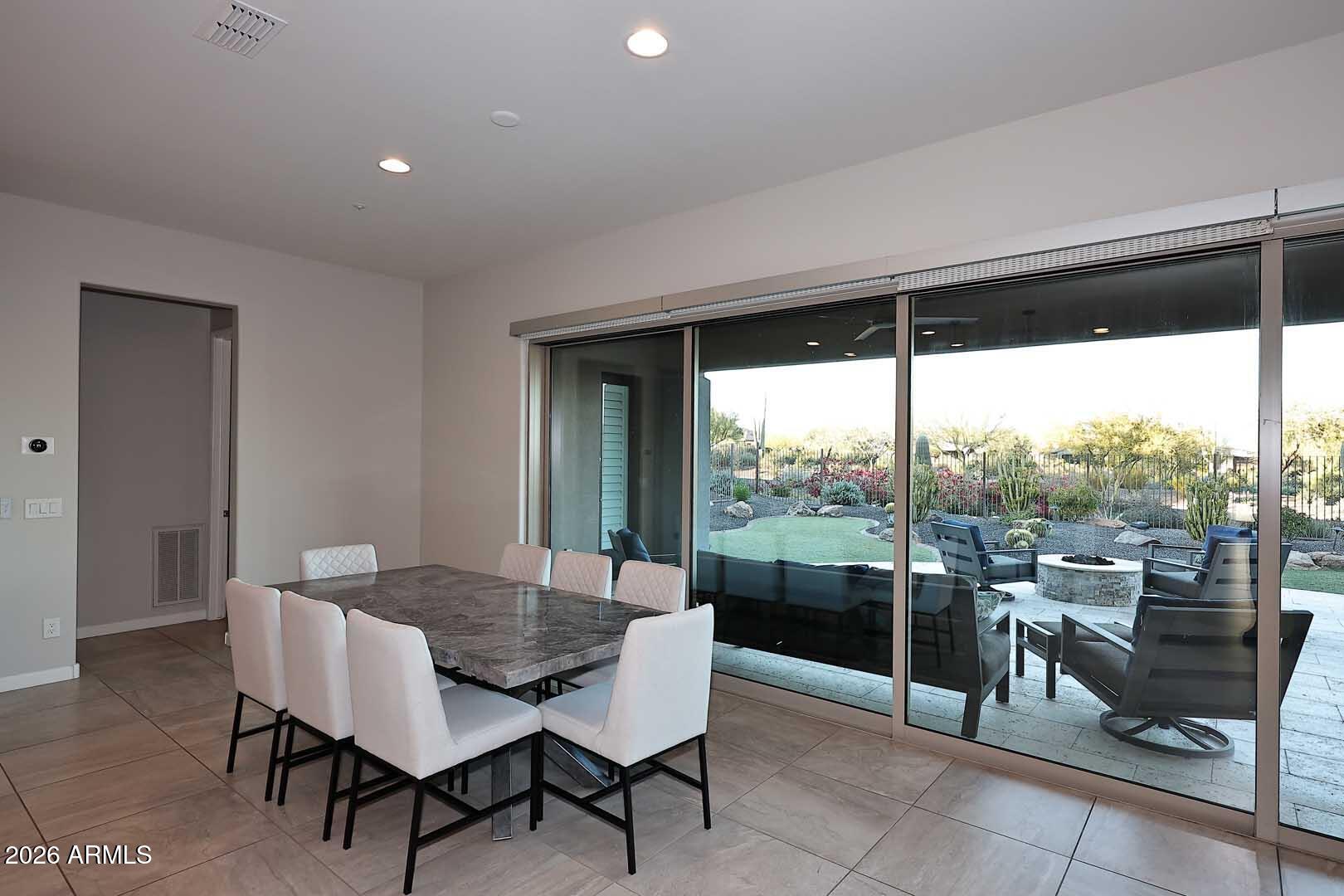 17916 East Cindercone Road Rio Verde, AZ 85263 - Photo 37 of 80 a dining room with furniture and a floor to ceiling window