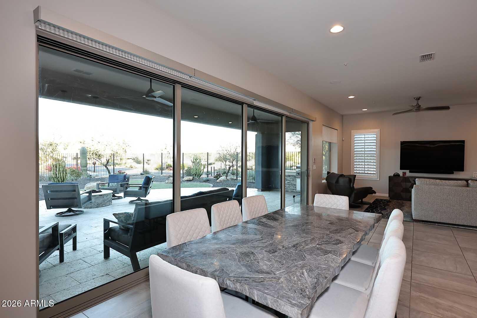 17916 East Cindercone Road Rio Verde, AZ 85263 - Photo 38 of 80 a living room with furniture a flat screen tv and a large window