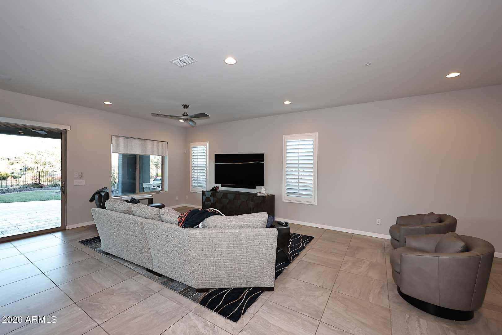 17916 East Cindercone Road Rio Verde, AZ 85263 - Photo 40 of 80 a living room with furniture and a flat screen tv