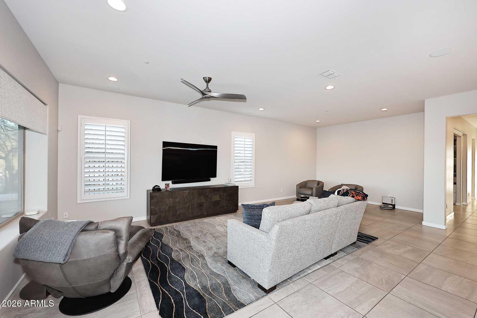 17916 East Cindercone Road Rio Verde, AZ 85263 - Photo 41 of 80 a living room with furniture and a flat screen tv