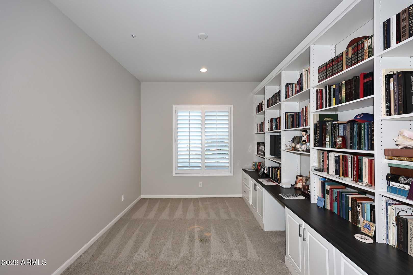 17916 East Cindercone Road Rio Verde, AZ 85263 - Photo 43 of 80 a hallway with a book shelf and a window