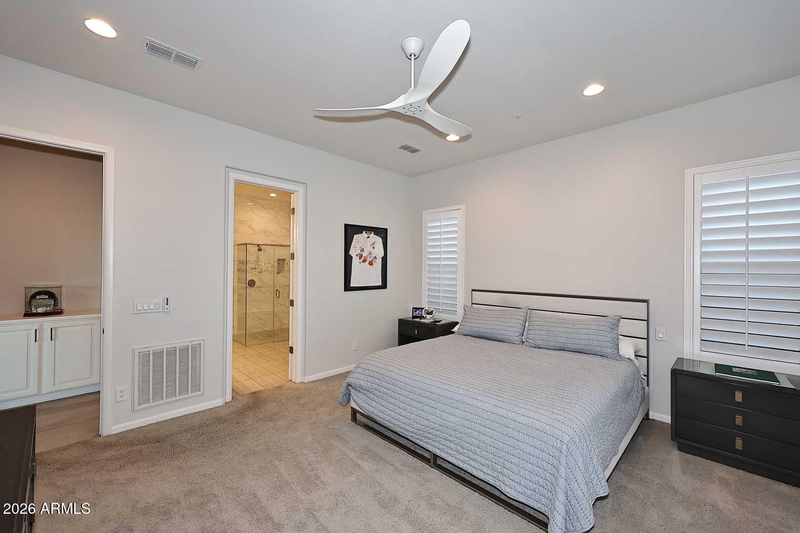 17916 East Cindercone Road Rio Verde, AZ 85263 - Photo 47 of 80 a bedroom with a large bed and a chandelier