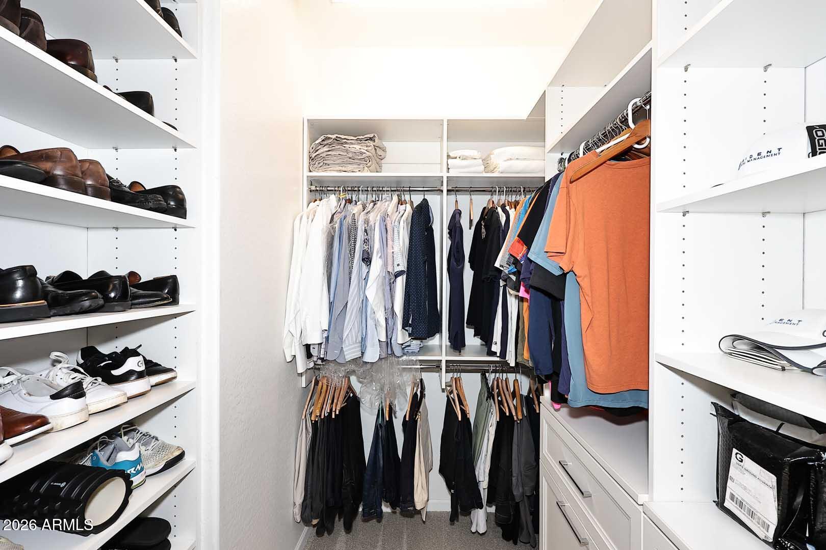 17916 East Cindercone Road Rio Verde, AZ 85263 - Photo 51 of 80 a view of walk in closet with clothes and shoes