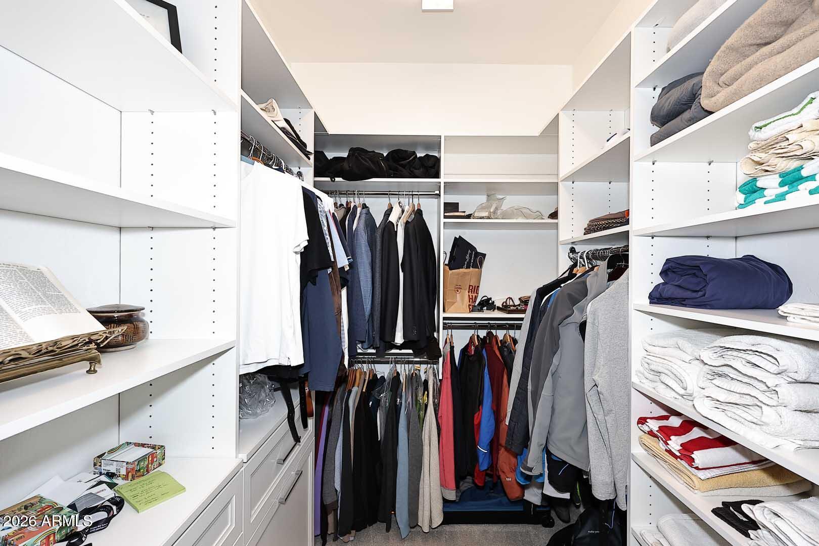 17916 East Cindercone Road Rio Verde, AZ 85263 - Photo 52 of 80 a view of walk in closet with clothes and shoes