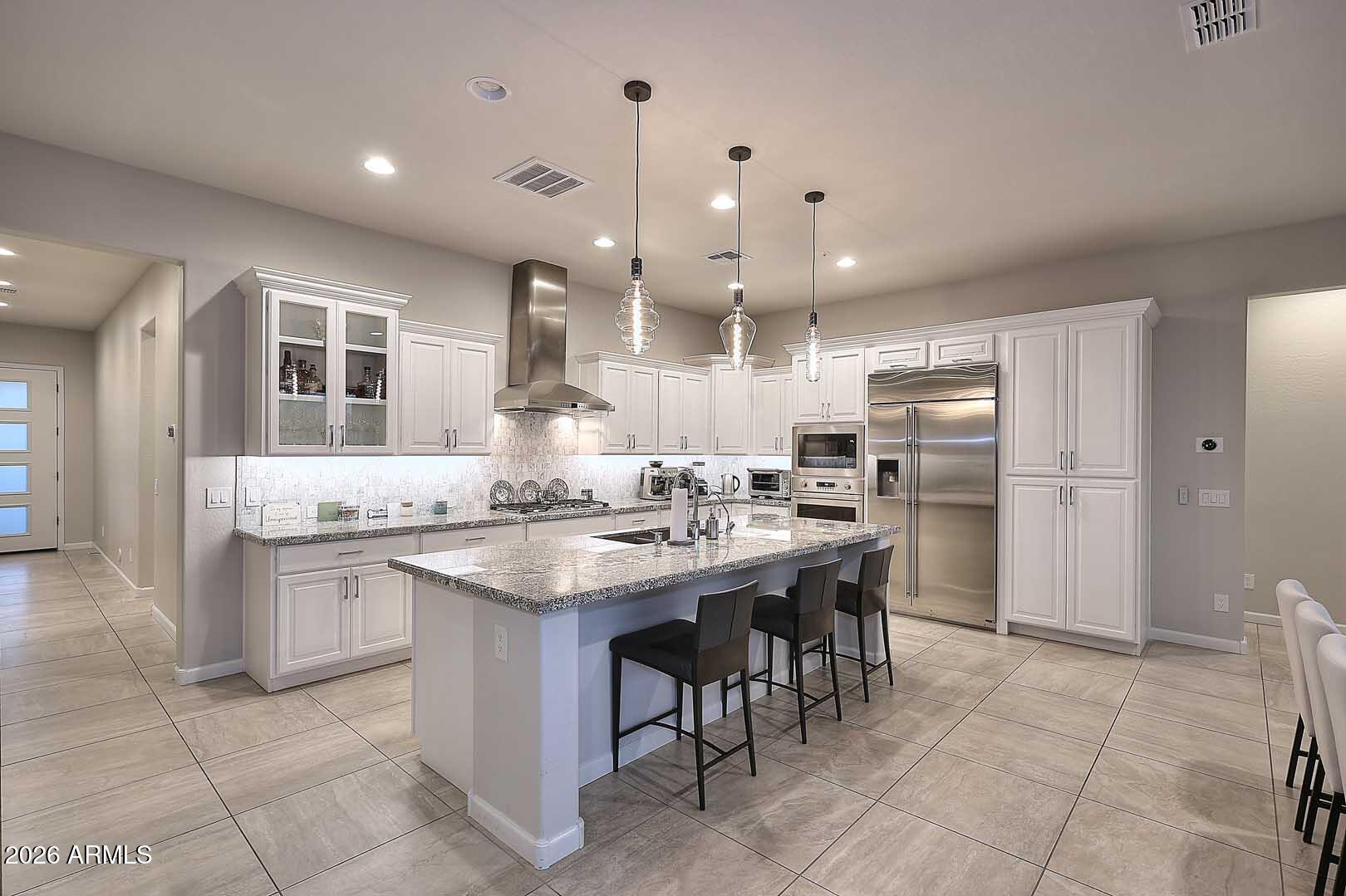 17916 East Cindercone Road Rio Verde, AZ 85263 - Photo 6 of 80 a kitchen with stainless steel appliances kitchen island granite countertop a sink and a refrigerator