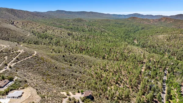 a view of a mountain range with lush green forest