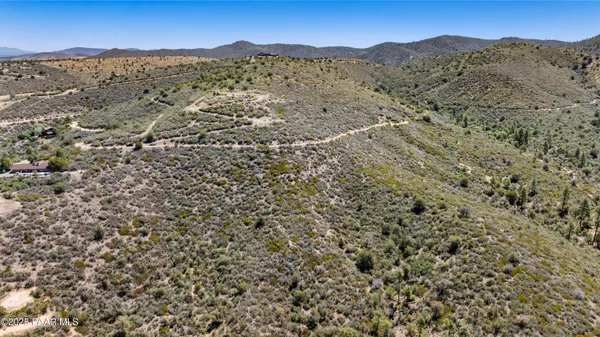 an aerial view of mountain with trees in the background