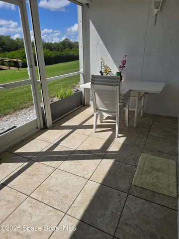 a view of a chairs and a table in the patio